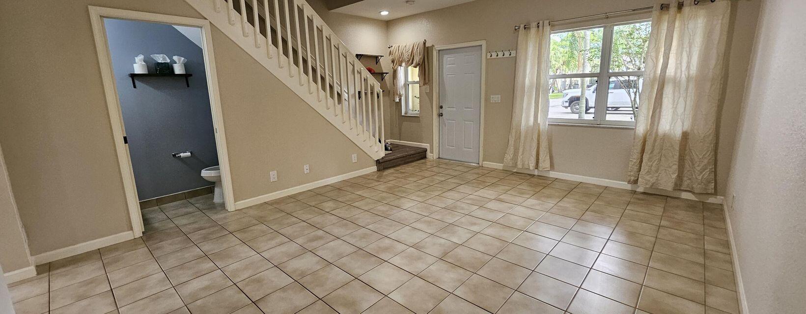 13490 Old Englishtown Road Wellington, FL 33414 - Photo 3 of 13 a view of an entryway with wooden floor and door