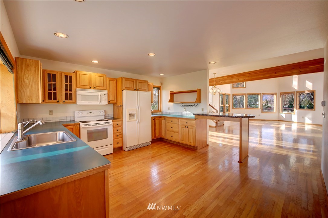 78 Woods Road Omak, WA 98841 - Photo 10 of 40 a kitchen with stainless steel appliances a sink and a refrigerator
