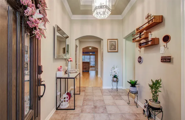 a view of an entryway with a flower pot and a bookshelf