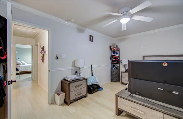 a bedroom with a bed and a flat tv screen on the dresser