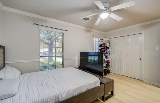 a bedroom with a bed and a bookshelf
