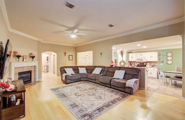 a living room with furniture a fireplace and a flat screen tv