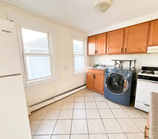 a utility room with sink dryer and washer