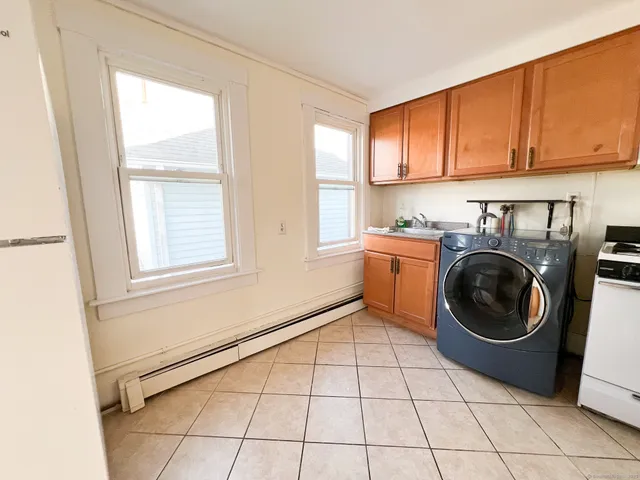 a view of a kitchen with washing machine and windows
