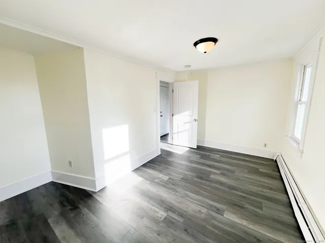 a view of an empty room and wooden floor