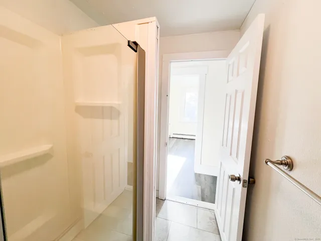 a bathroom with a shower and a tub