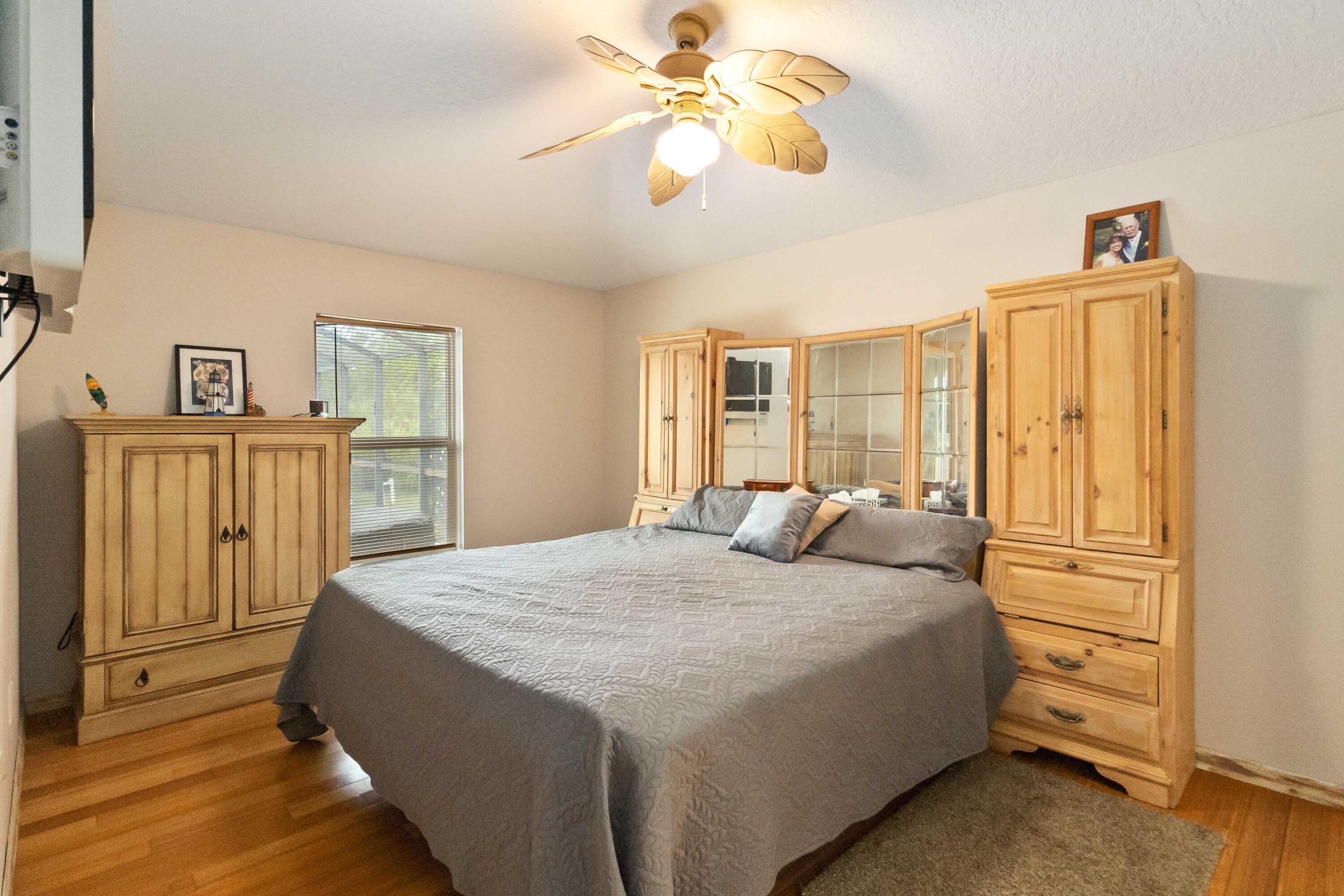 1364 Ran Road Southeast Palm Bay, FL 32909 - Photo 16 of 26 a bedroom with a bed and a chandelier