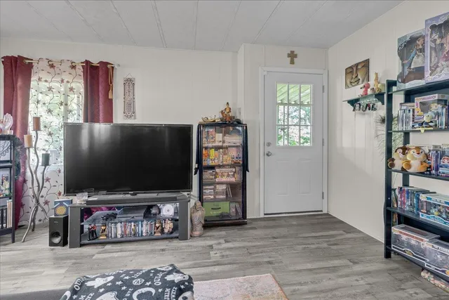a bedroom with a bed couch and a window