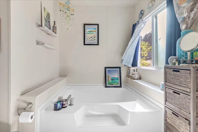 a bathroom with a bathtub sink and mirror