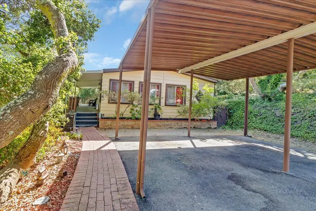 a view of a patio with table and chairs and floor to ceiling window