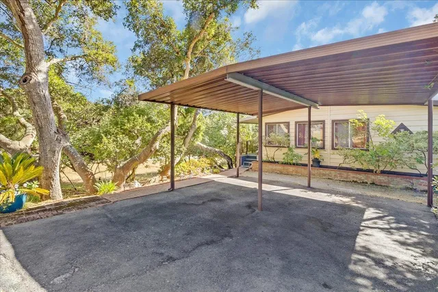 a view of an house with backyard and balcony