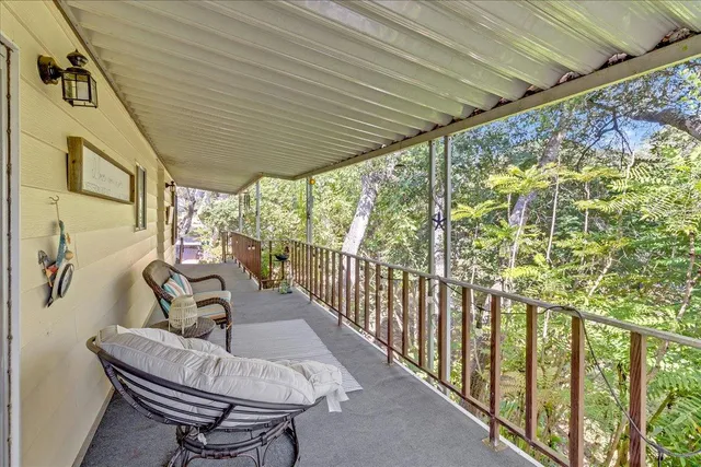 a view of two chairs in the balcony