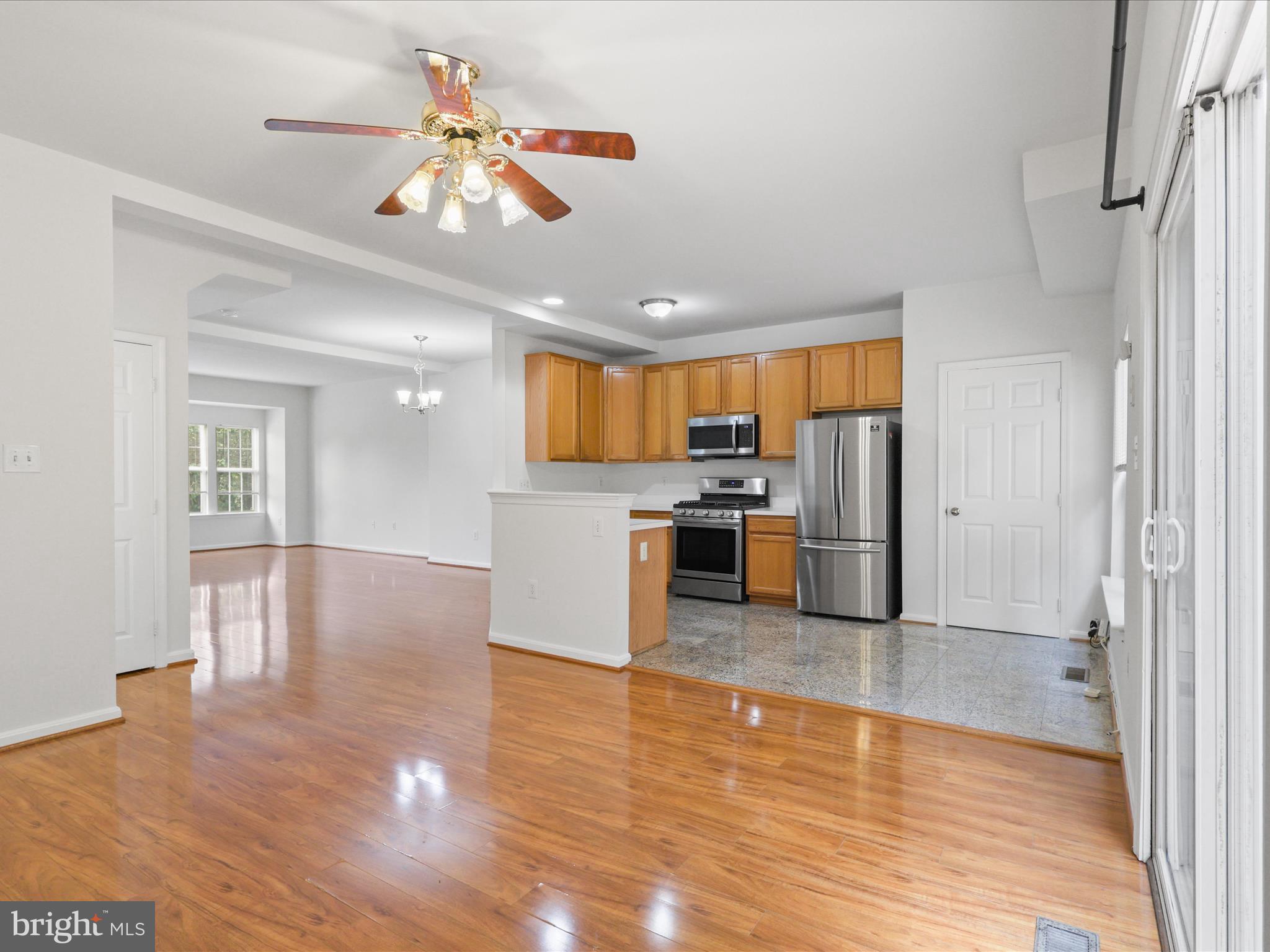 7700 Shadowcreek Terrace Springfield, VA 22153 - Photo 12 of 44 a kitchen with stainless steel appliances granite countertop a refrigerator and a stove top oven