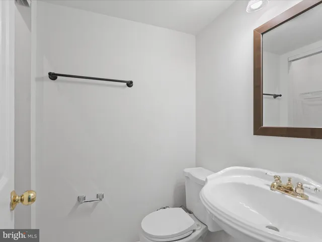 a white toilet sitting next to a bathroom sink