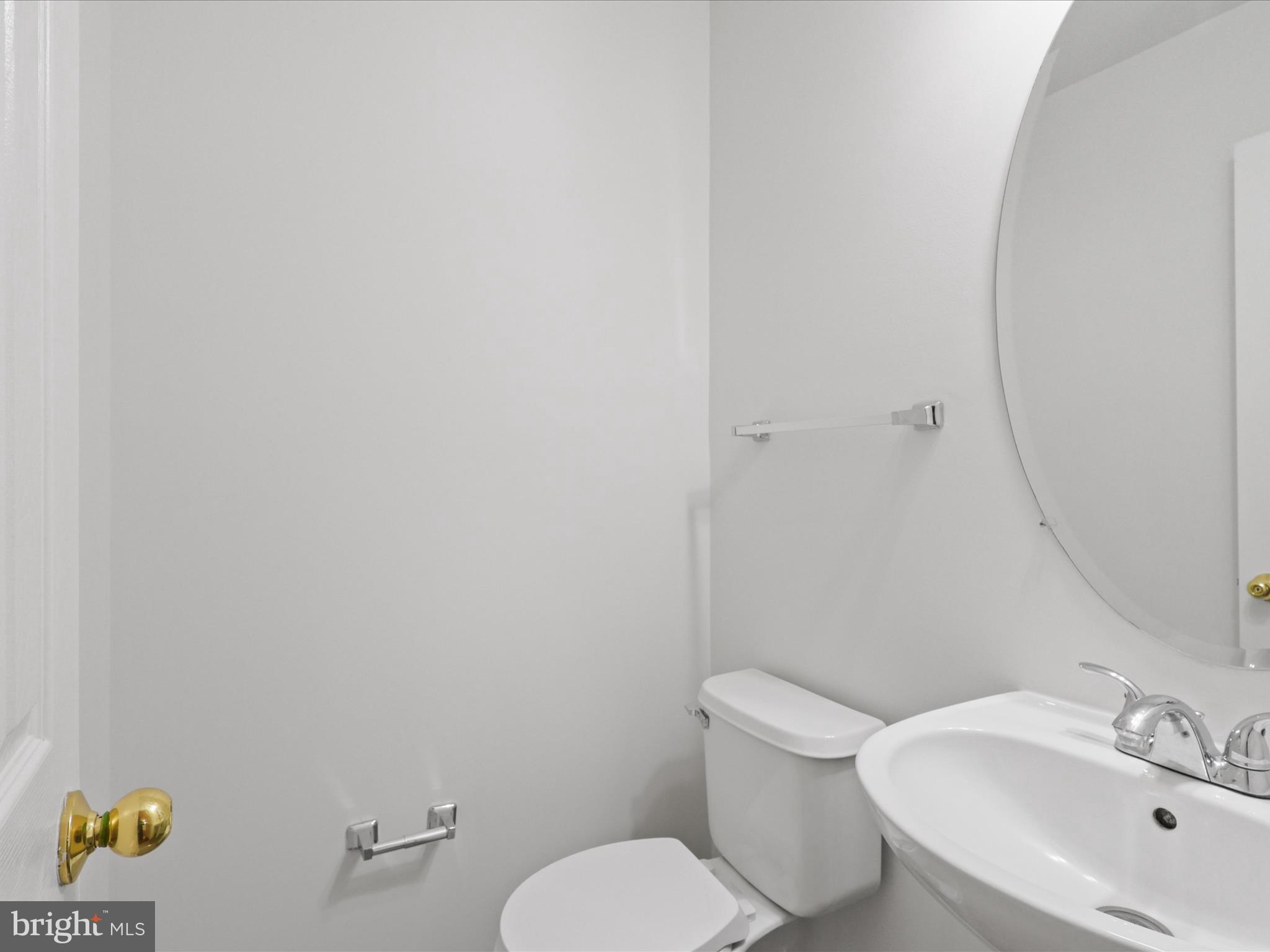 7700 Shadowcreek Terrace Springfield, VA 22153 - Photo 21 of 44 a white toilet sitting next to a white sink and a mirror