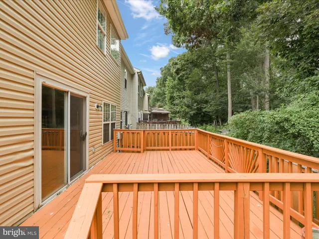 a view of balcony with wooden floor and fence