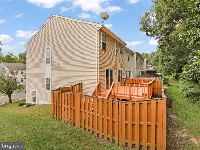 a view of a house with a wooden fence