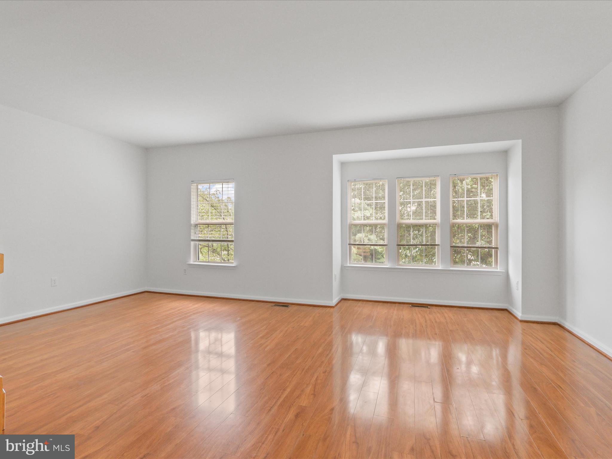 7700 Shadowcreek Terrace Springfield, VA 22153 - Photo 8 of 44 an empty room with wooden floor and windows