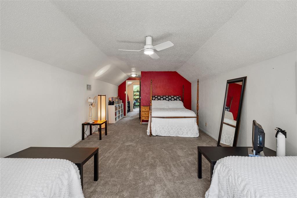 105 Gail Drive Waco, TX 76708 - Photo 25 of 36 a bedroom with furniture and a chandelier