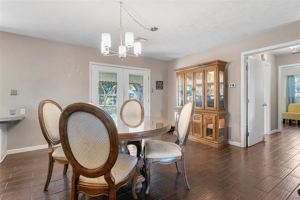 105 Gail Drive Waco, TX 76708 - Photo 6 of 36 a dining room with wooden floor a chandelier a glass table and chairs