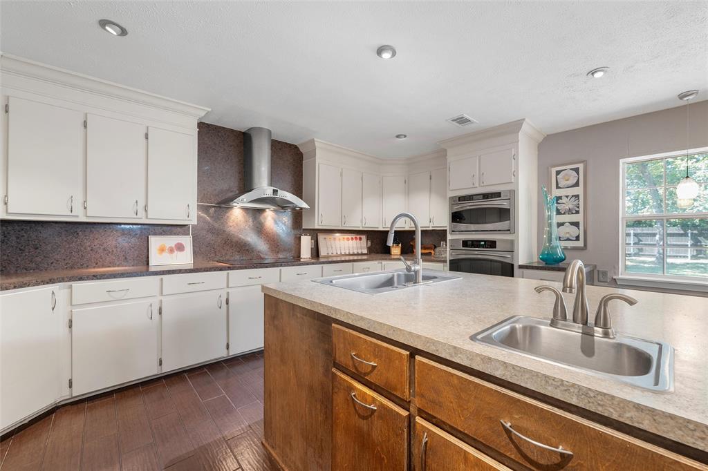 105 Gail Drive Waco, TX 76708 - Photo 9 of 36 a kitchen with stainless steel appliances granite countertop a sink stove and cabinets