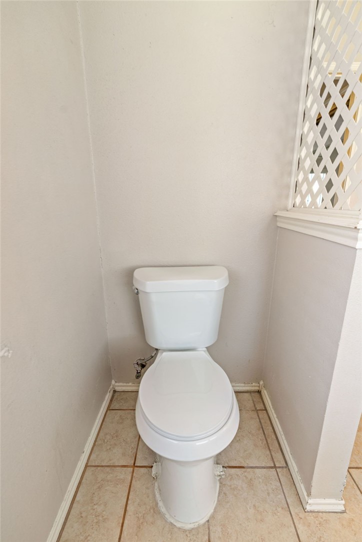 7209 Candy Ridge Road Corpus Christi, TX 78413 - Photo 22 of 24 a white toilet sitting next to a small window