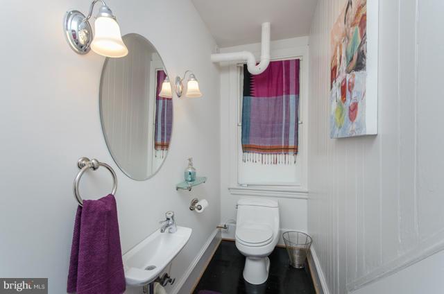 706 E Street Southeast Washington, DC 20003 - Photo 9 of 19 a bathroom with a toilet sink and mirror