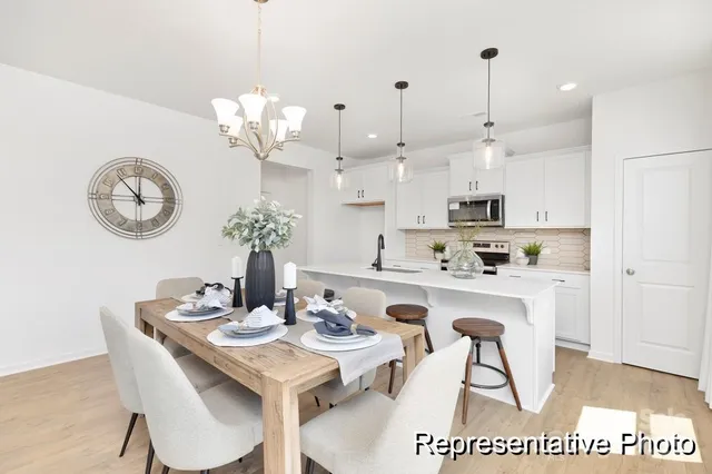 a view of kitchen with sink and refrigerator