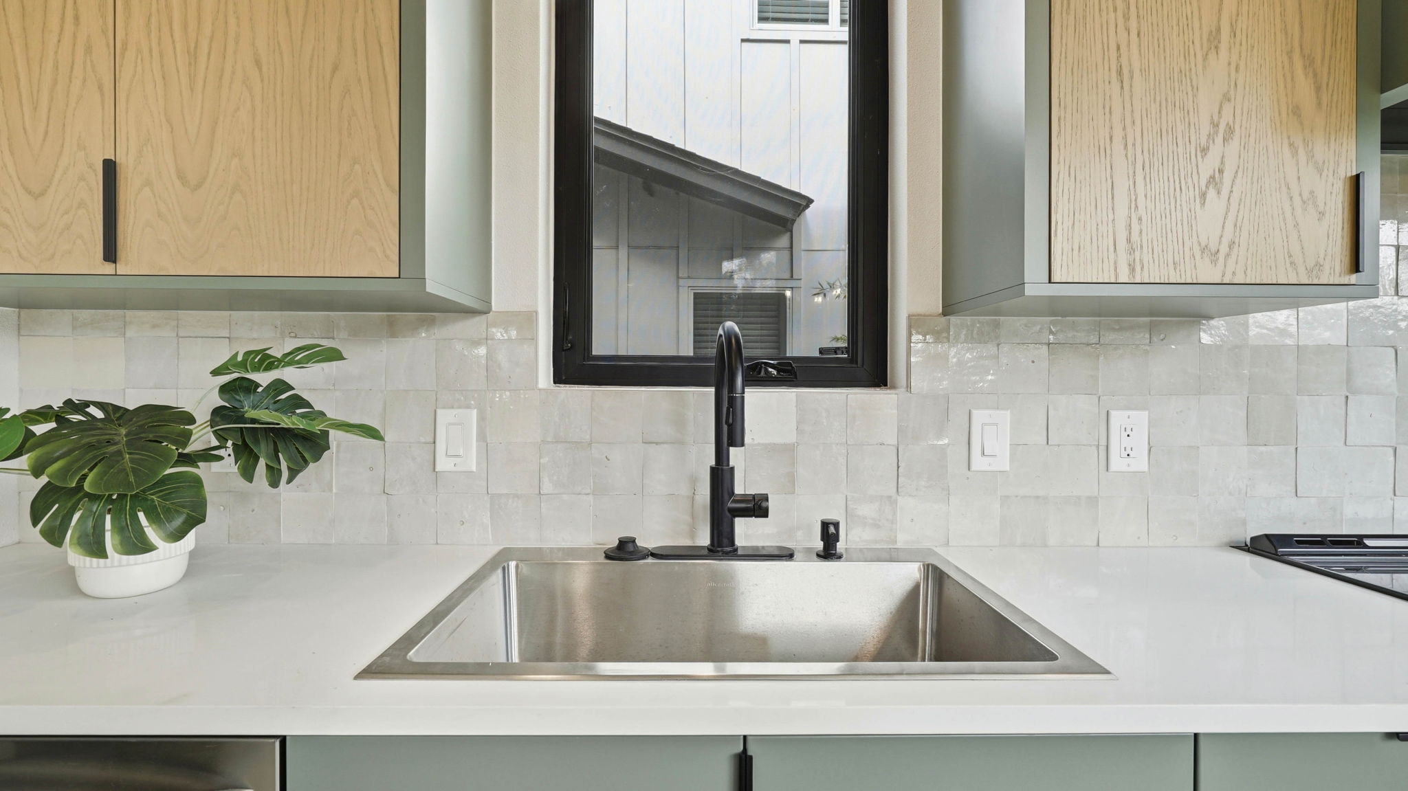 300 Lightsey Road, Unit 2 Austin, TX 78704 - Photo 11 of 28 Kitchen view of light stone counters, backsplash, and dishwasher