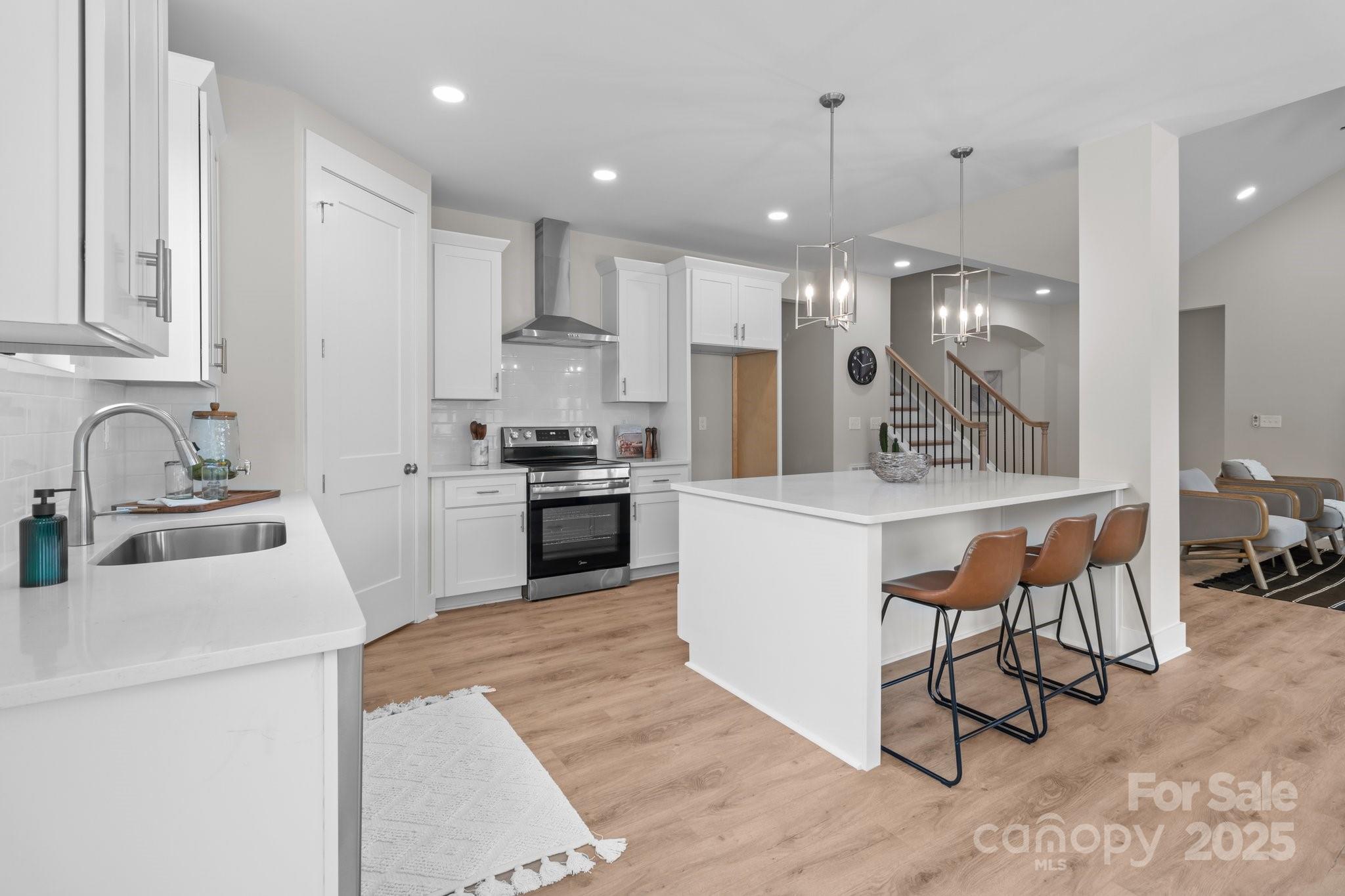 4949 Rimer Road, Unit 4 Concord, NC 28025 - Photo 2 of 46 a kitchen with stainless steel appliances kitchen island granite countertop a sink a stove a refrigerator and cabinets
