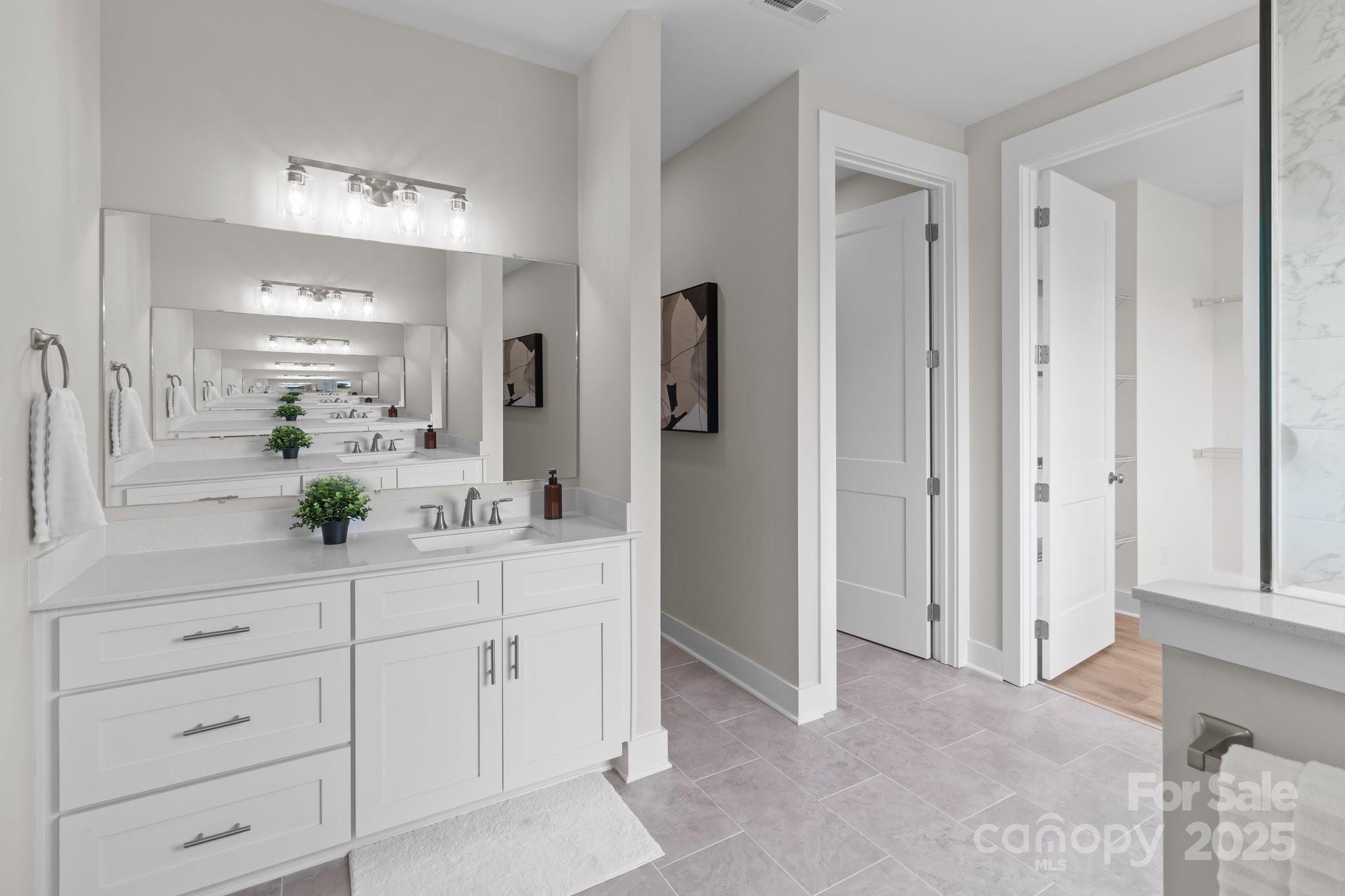 4949 Rimer Road, Unit 4 Concord, NC 28025 - Photo 7 of 46 a bathroom with a double vanity sink and mirror
