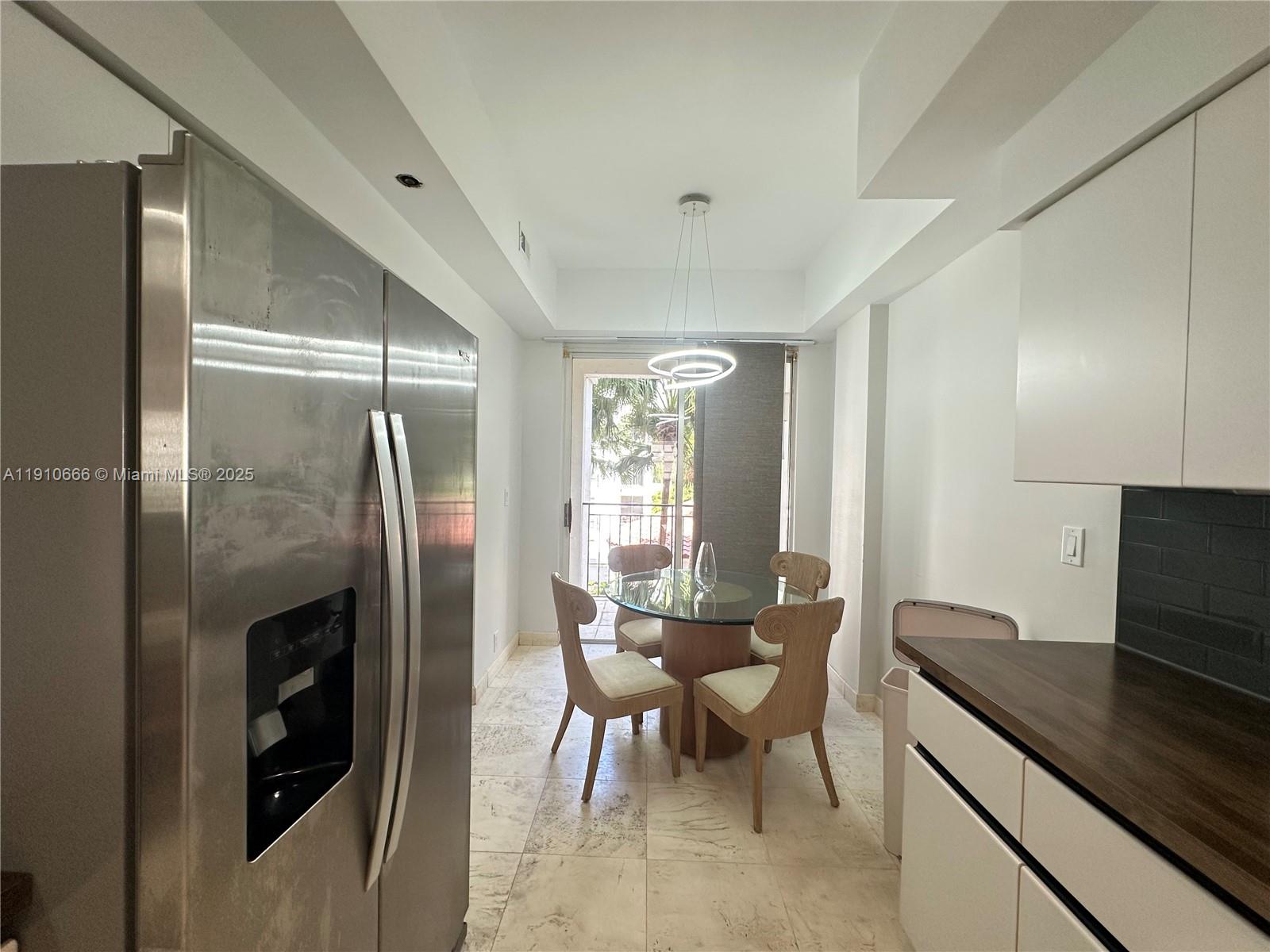 3900 Island Boulevard, Unit B303 Aventura, FL 33160 - Photo 16 of 35 a kitchen with stainless steel appliances granite countertop a refrigerator and a stove top oven