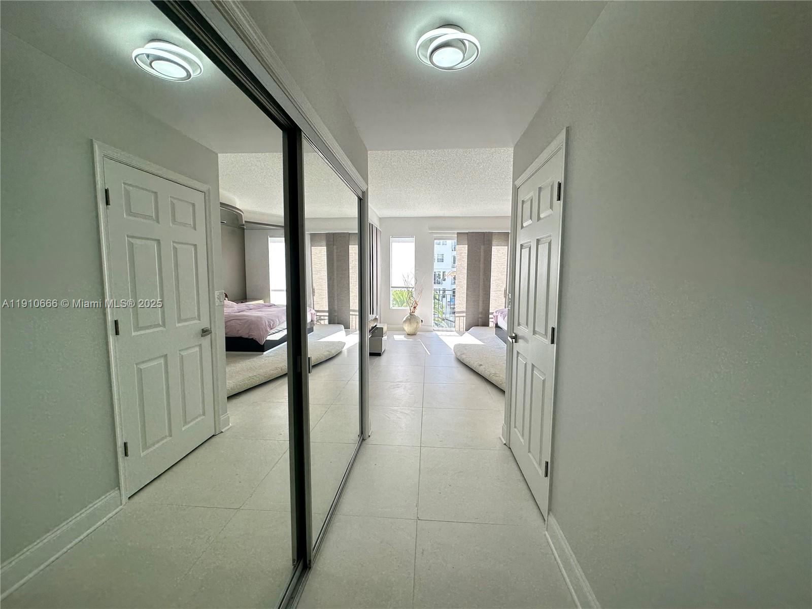 3900 Island Boulevard, Unit B303 Aventura, FL 33160 - Photo 20 of 35 a view of a hallway with furniture and a livingroom view