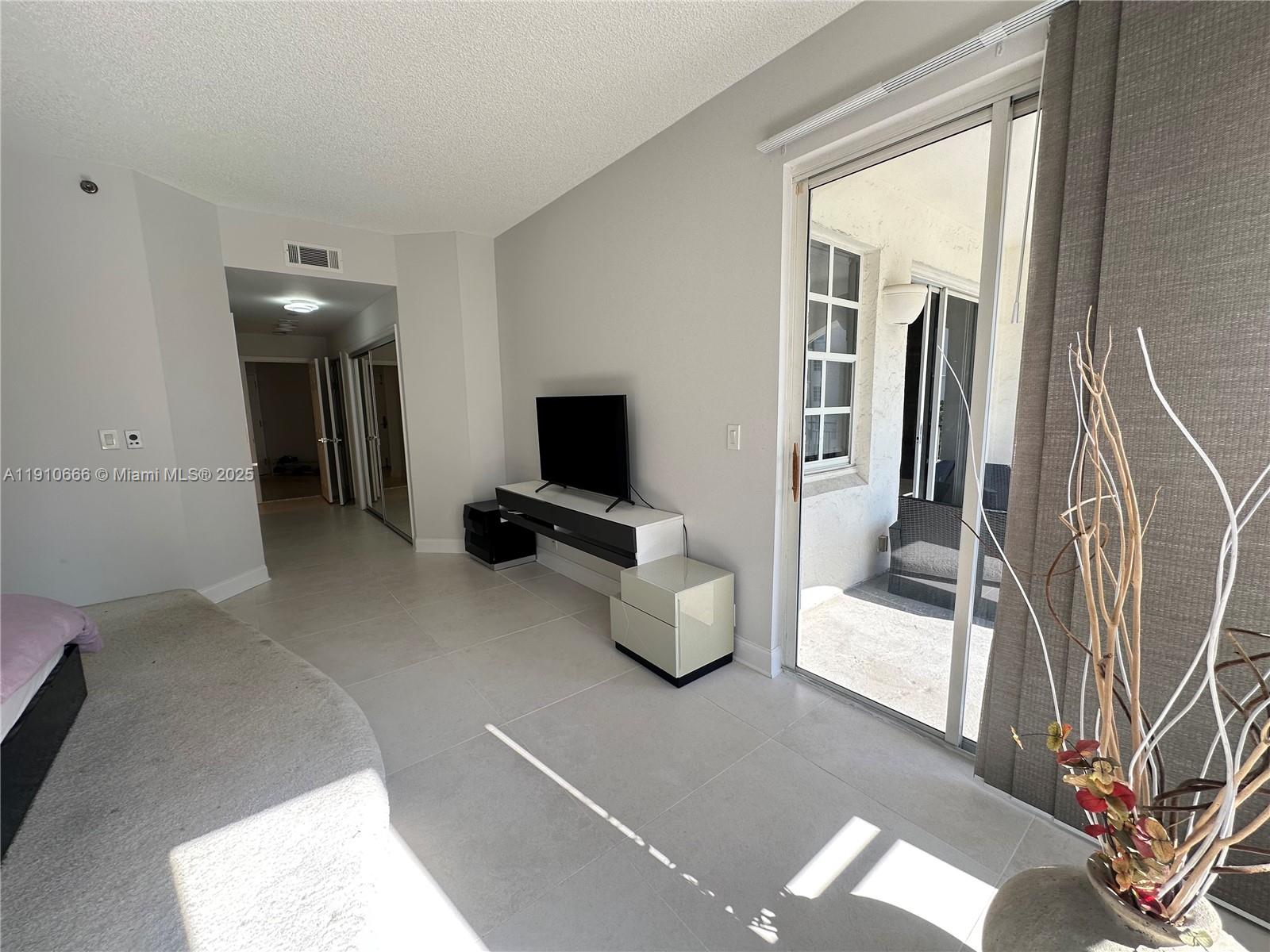 3900 Island Boulevard, Unit B303 Aventura, FL 33160 - Photo 25 of 35 a view of livingroom with furniture and flat screen tv