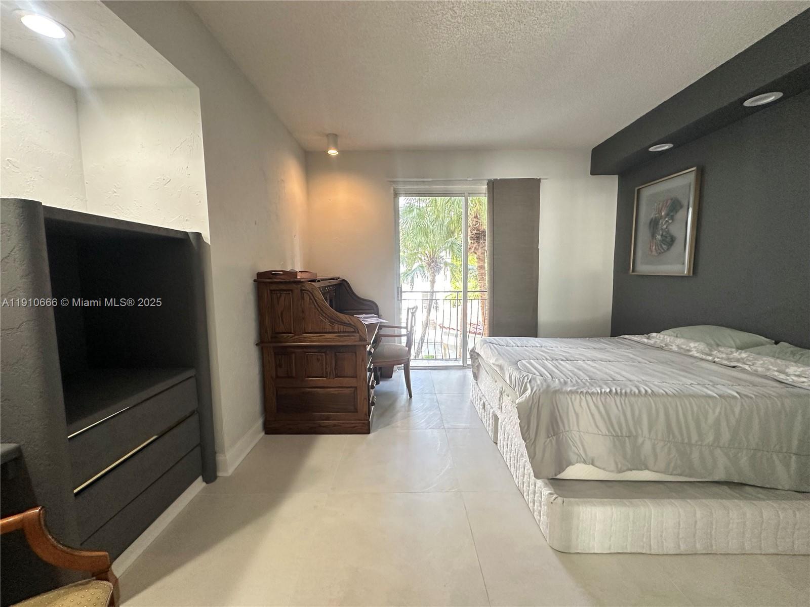 3900 Island Boulevard, Unit B303 Aventura, FL 33160 - Photo 33 of 35 a bedroom with a bed and a television