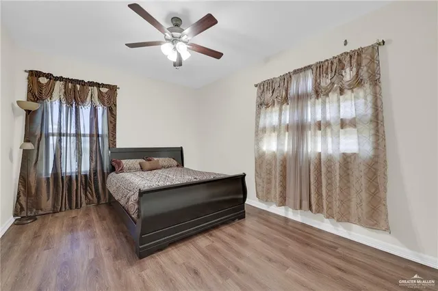 a bathroom with a granite countertop double vanity sink and mirror with shower