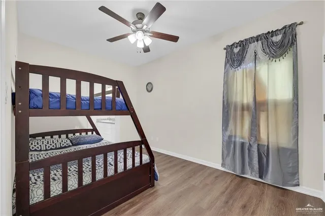 a living room with furniture and a ceiling fan
