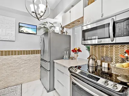 a kitchen with stainless steel appliances granite countertop a stove and a refrigerator