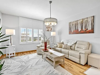 a living room with furniture a table and a window