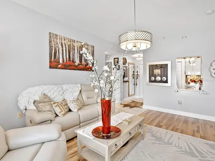 a living room with furniture and a chandelier