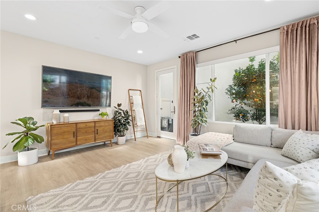 163 Tenor Irvine, CA 92618 - Photo 14 of 40 a living room with furniture and a flat screen tv