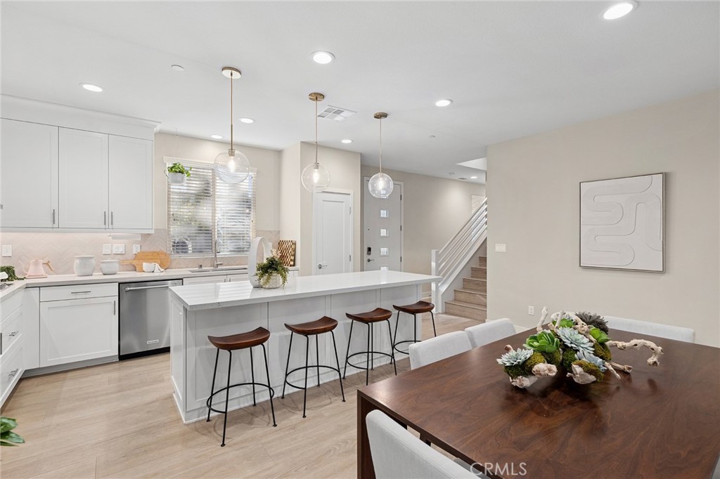 163 Tenor Irvine, CA 92618 - Photo 22 of 40 a kitchen with a table chairs sink and cabinets