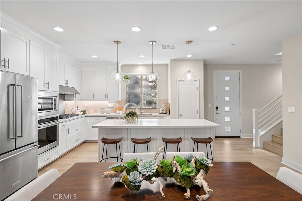 163 Tenor Irvine, CA 92618 - Photo 23 of 40 a kitchen with kitchen island granite countertop lots of counter top space appliances and cabinets