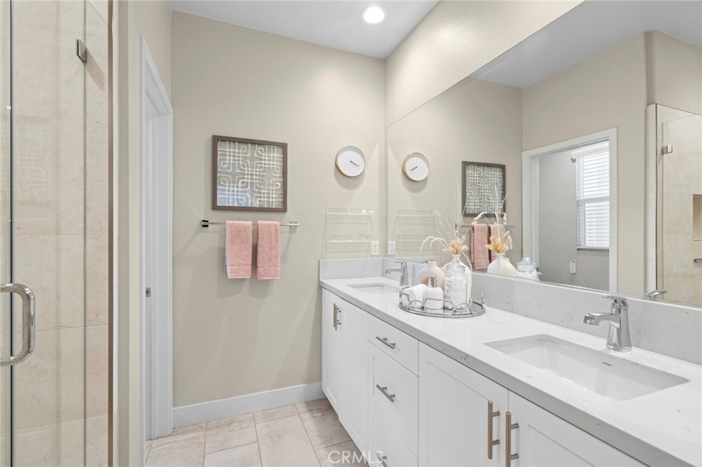 163 Tenor Irvine, CA 92618 - Photo 27 of 40 a bathroom with a double vanity sink and a mirror