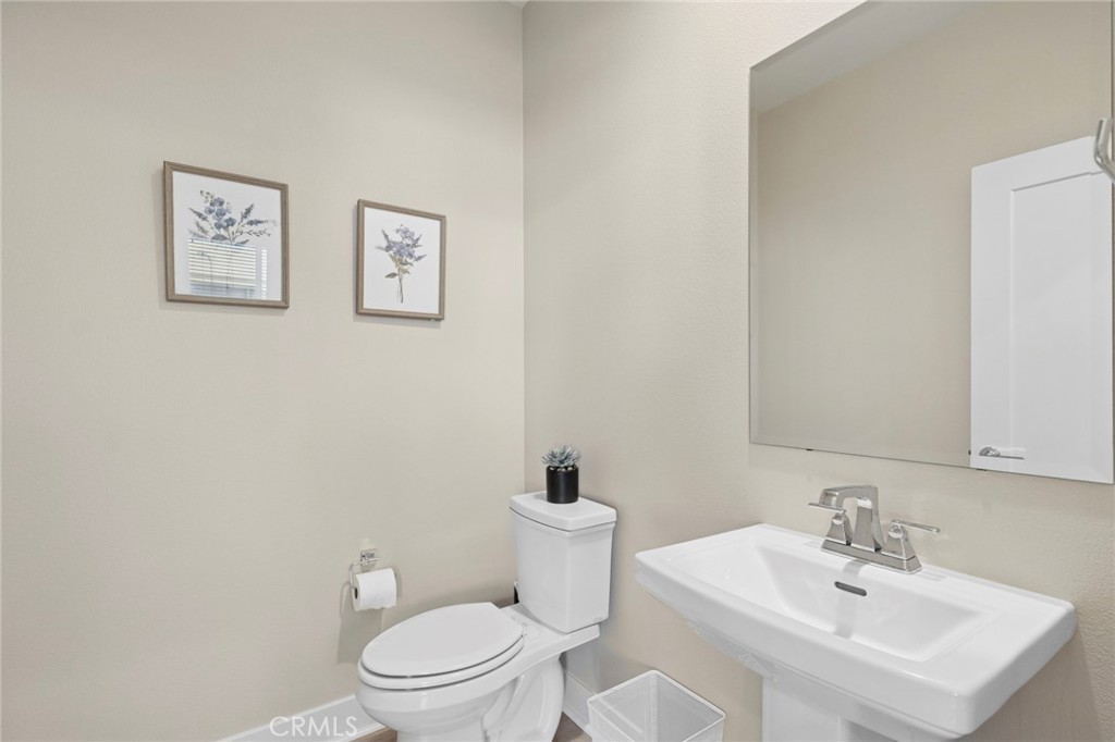 163 Tenor Irvine, CA 92618 - Photo 32 of 40 a bathroom with a toilet a sink and mirror