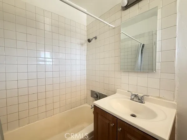 a bathroom with a sink shower and a bathtub