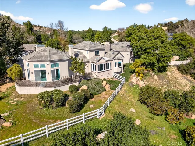 a view of a house with pool and sitting area