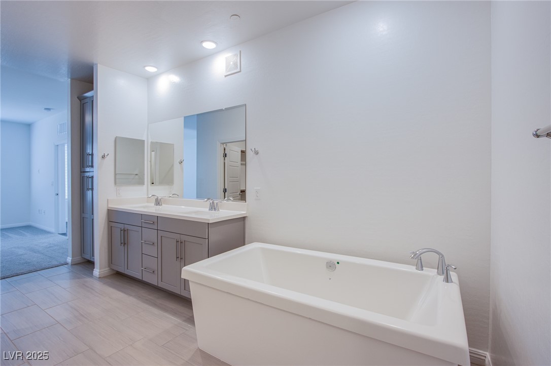 2555 Hampton Road, Unit 4109 Henderson, NV 89052 - Photo 15 of 38 Bathroom with double vanity and a freestanding tub
