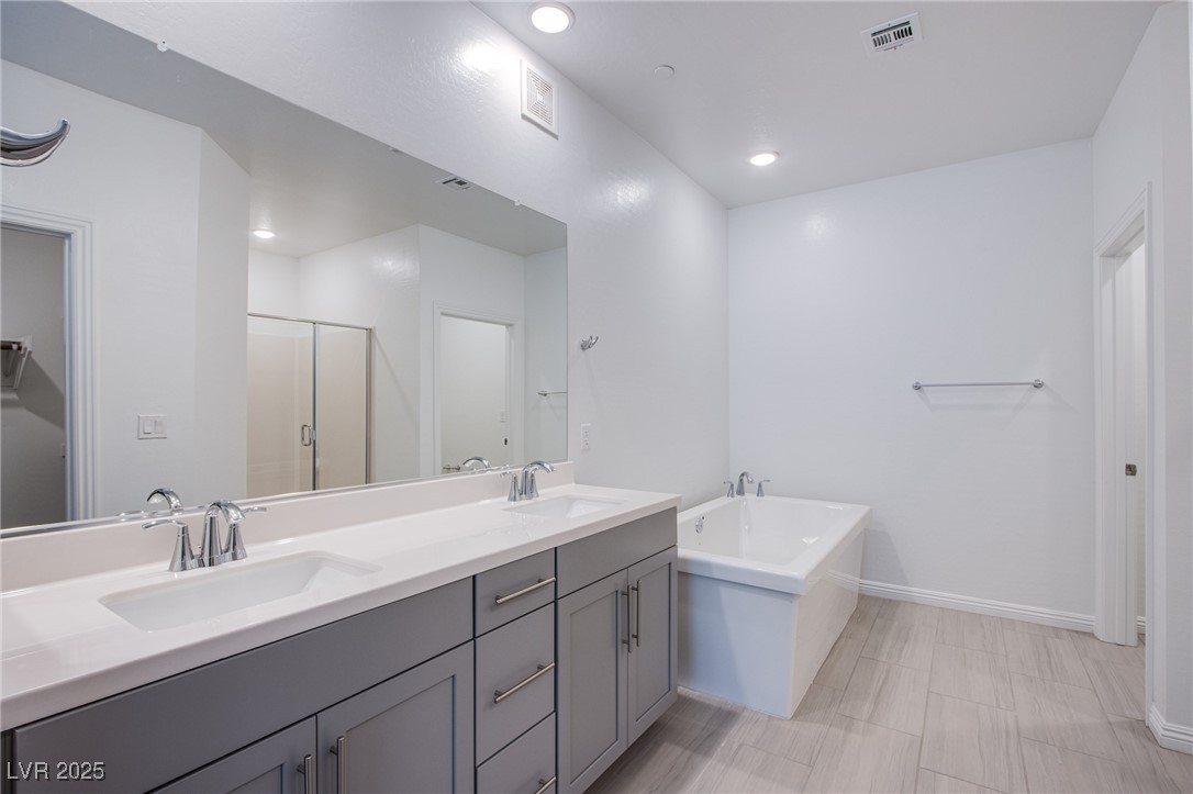 2555 Hampton Road, Unit 4109 Henderson, NV 89052 - Photo 21 of 38 Bathroom with double vanity, a bath, a stall shower, and recessed lighting