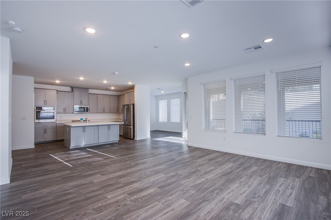 2555 Hampton Road, Unit 4109 Henderson, NV 89052 - Photo 38 of 38 Kitchen with stainless steel appliances, open floor plan, gray cabinets, light countertops, and dark wood-style floors